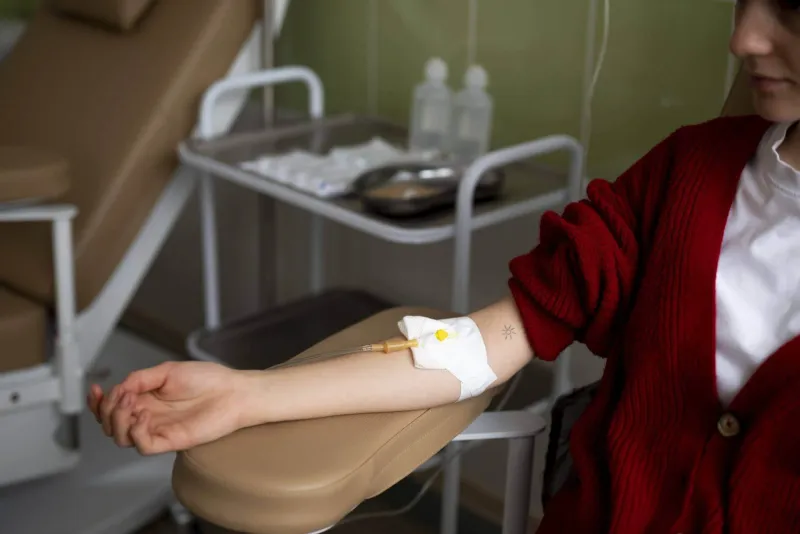 woman sitting while on hydration iv therapy in miami 1